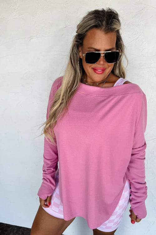 Mauvy pink athleisure top styled off the shoulder with casual shorts.