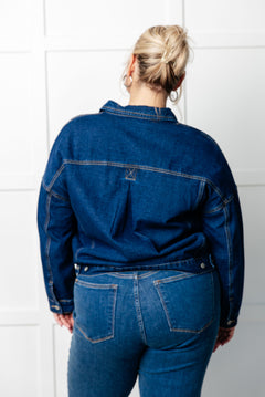 Back view of the jacket showcasing the pleat detail and oversized fit.