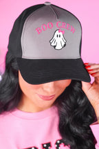 Person wearing a cap with 'BOO CREW' and a ghost design on a pink background