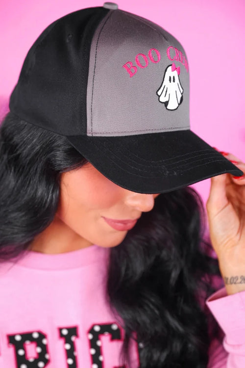 Person wearing a black and gray cap with 'BOO CREEP' text and ghost graphic against a pink background