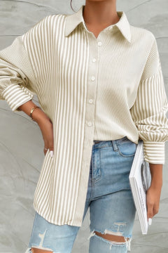 Woman wearing striped button down shirt in beige with long sleeves and collar
