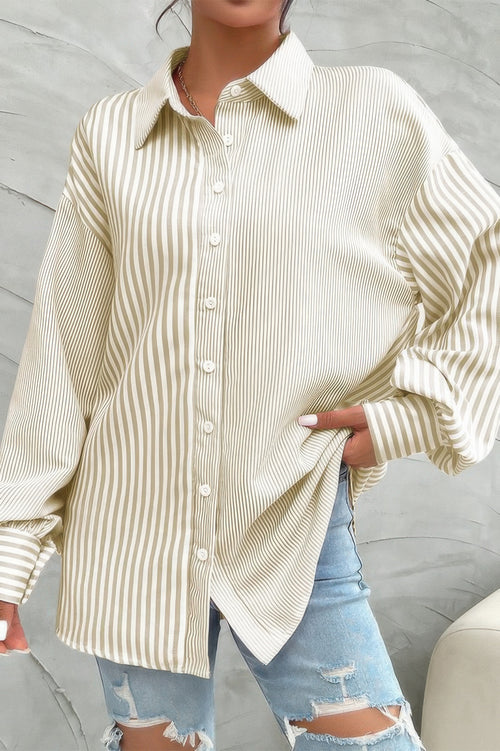 Woman wearing striped button down shirt in beige with long sleeves and collar