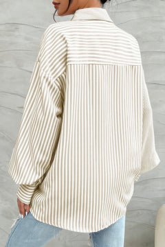 Woman wearing striped button down shirt in beige with long sleeves and collar- back view
