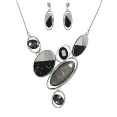 Jewelry set with necklace and earrings featuring black and silver stones on a white background