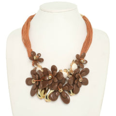 Stone Bloom Statement Necklace featuring marbled floral beads, floral charms, and multi-strand brown cords.