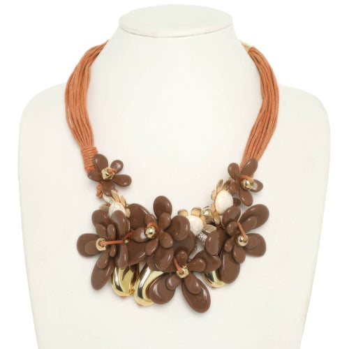 Stone Bloom Statement Necklace featuring marbled floral beads, floral charms, and multi-strand brown cords.