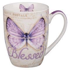 Mug with butterfly design and 'Blessed' text on a white background
