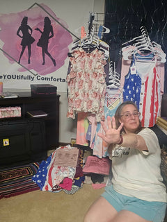 Boutique owner holding up five fingers to signal the $5 flash sale in front of a "BeYoutiful Comfort" logo and racks of clothing.