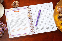 Open book with a puzzle titled 'Nothing is Impossible' on a wooden surface with decorative elements.