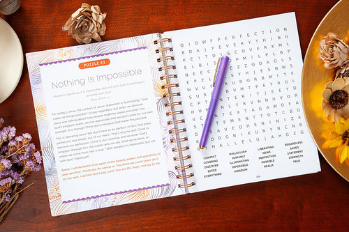 Open book with a puzzle titled 'Nothing is Impossible' on a wooden surface with decorative elements.