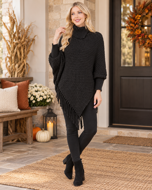 Black cozy cowl neck fringe poncho styled for fall