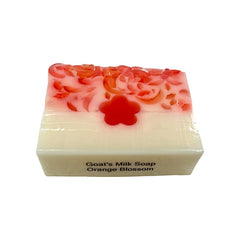 Bar of goats' milk soap with orange blossom fragrance on a white background