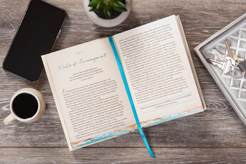 Interior page of Dear Anxiety devotional showing Day 13 'Words of Encouragement' and a teal ribbon bookmark.