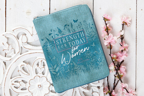 Blue pouch with 'Strength for Today for Women' text on a decorative white surface with flowers.