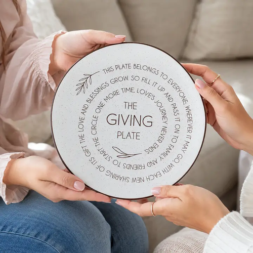 Two people exchanging the Giving Plate as a heartfelt gift