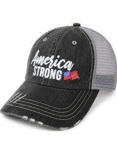 A distressed black trucker cap with a gray mesh back, featuring 'America Strong' embroidered on the front in white, with a small American flag graphic.