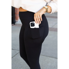 Black leggings side pocket holding a phone