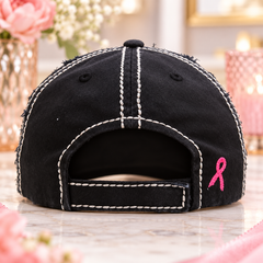 Back view of black distressed baseball cap with adjustable closure and small pink ribbon embroidery